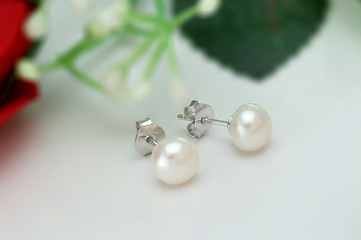 Pearl Earring on flower blur background