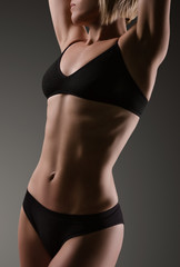 Female sexy body in black underwear.  Woman body care.