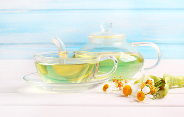 teapot and cup herbal tea wood background
