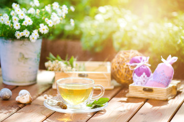Cup of tea on a wooden backgound. Flowers and grass. Natural background. Agricultural.Garden 