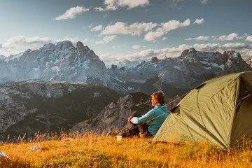 sportsman in high mountains camping