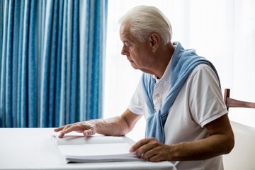 Senior man using braille to read