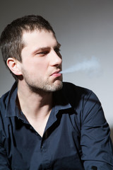 Beautiful young man with tobacco pipe