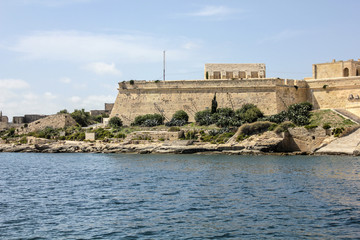 Fototapeta premium The city walls of Valletta with old castle