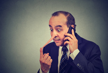 Liar customer service representative. Man with long nose talking on mobile phone lying