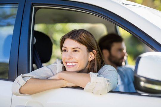 Thoughtful Woman Looking Out From Car Window