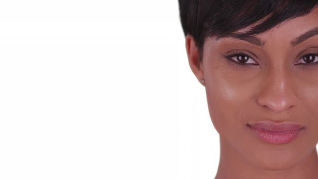 Close up of Beautiful woman with small smile on her face on white background. Black woman in her 20s with short pixie hair cut.