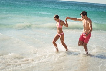 Couple running in water