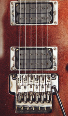 Electric guitar detail view, zoom in to floyd rose, very shallow depth of field image, cinematic effect applied