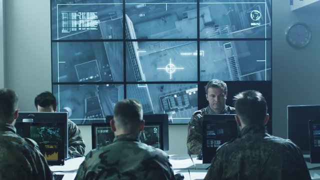 Group of Military IT Professionals on Briefing in Monitoring Room Filled with Displays on Military Base. Shot on RED Cinema Camera in 4K (UHD).