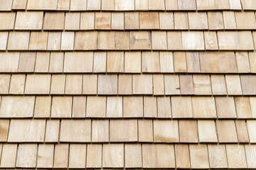 Several wood cedar shingles for siding or roofs.