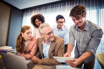 Fototapeta premium Business people discussing over digital tablet