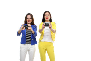 the portraits of two young girls makes a photo by camera isolated on white background
