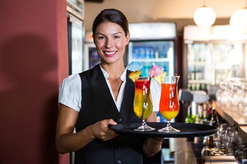 Waitress holding cocktails