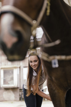 Portrait of smiling young woman with brown horse