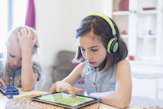 Two girls using mobile devices