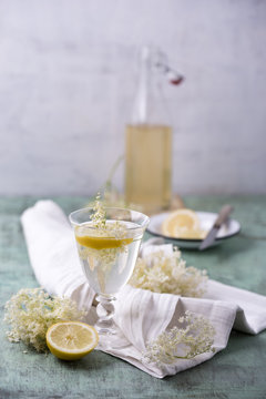 Glass of water flavoured with elderflower sirup and lemon