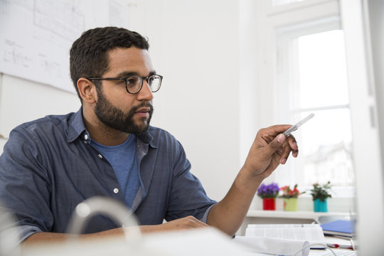 Young man working at desk in office