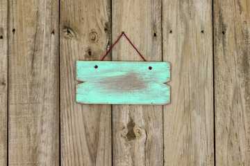 Blank mint green sign hanging on wood background