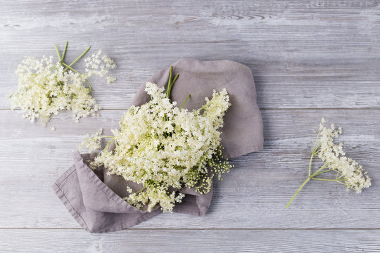 Elderflowerrs on cloth and wood