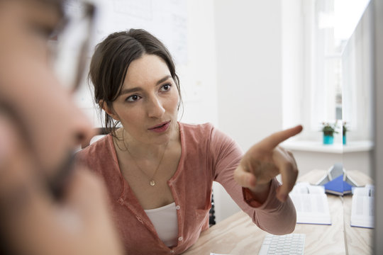 Two creative professionals working in office