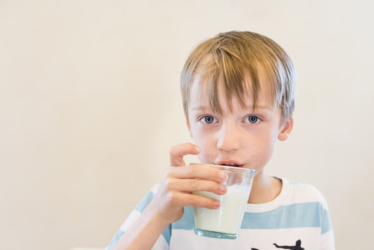 Boy drinking glass of milk