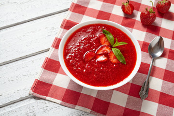 Strawberry soup healthy vegetarian summer fruit dessert food, vitamin rich nutrition meal on white vintage background