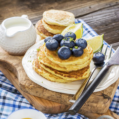 Healthy breakfast classic. Several domestic hot pancakes with fresh ripe blueberry lime zest, honey