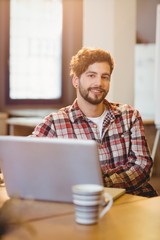 Portrait of graphic designer working on laptop
