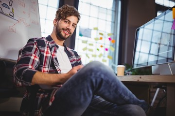 Portrait of creative businessman using digital tablet 