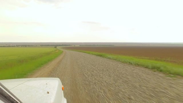 Driving car through the countryside road. Wiew from wheel, low angle, super stabilized