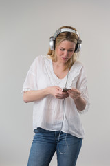 portrait of a young girl listening music with headphones