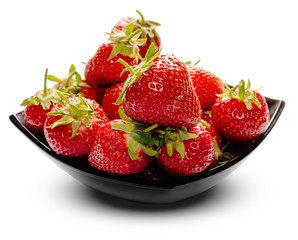 Strawberries with leaves in black plate, isolated on a white background.