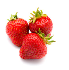 Three trawberries with leaves, isolated on a white background.