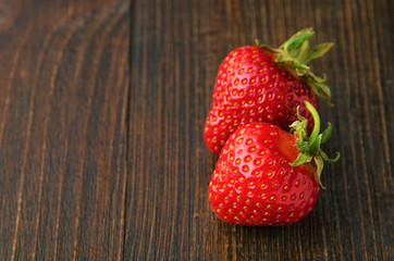 Fresh tasty strawberries on old wooden background