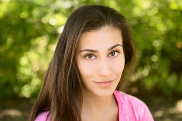 Naklejka premium portrait of the young woman outdoors in summer day