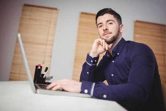 Portrait of man working at office