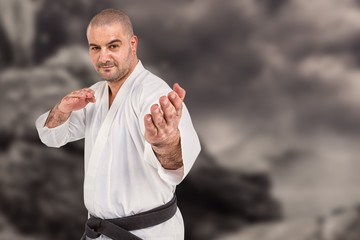 Naklejka premium Composite image of fighter performing karate stance