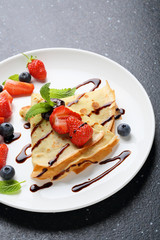 crepes with strawberry on white plate