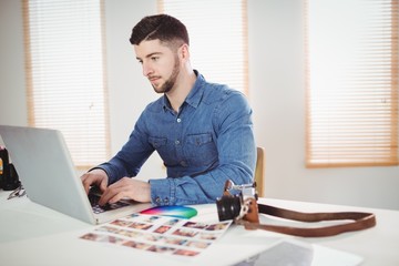Fototapeta na wymiar Man working on laptop at office