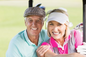 Fototapeta na wymiar Portrait of cheerful golfer couple 