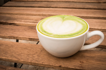 cup of green tea on the wood background