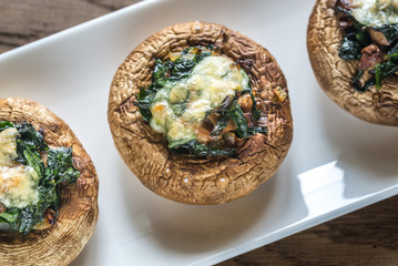 Obraz na płótnie Canvas Baked mushrooms stuffed with spinach and cheese