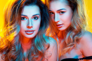 Naklejka premium beautiful girls in colorful light