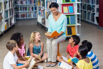 Teacher with students reading books 