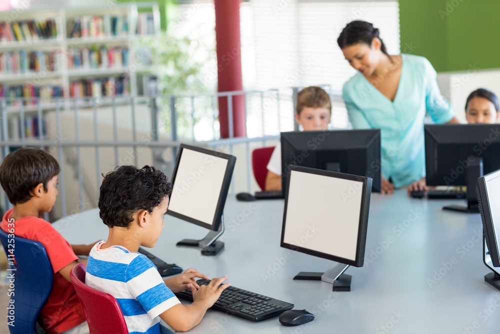 Poster children using computers as teacher teaching them