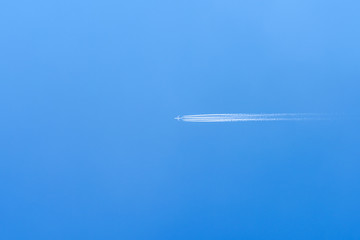 Airplane Trail On Clear Blue Sky