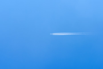 Airplane Trail On Clear Blue Sky