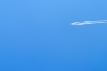 Airplane Trail On Clear Blue Sky