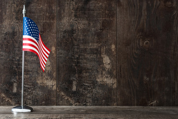 United States flag on a rustic wooden background

